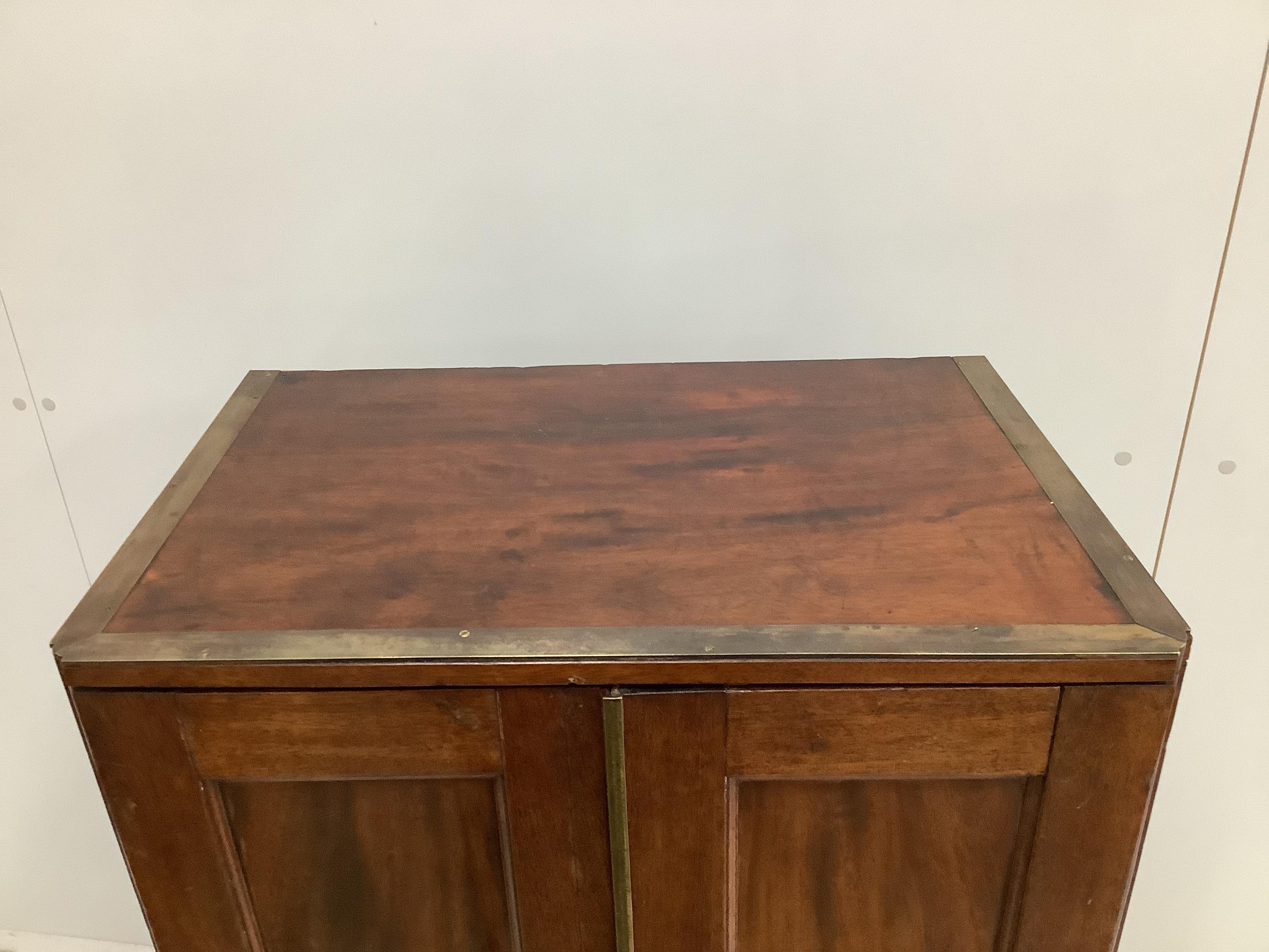 A 19th century brass mounted mahogany pigeonhole cabinet with tapered right side, possibly from a ship, width 53cm, depth 34cm, height 112cm